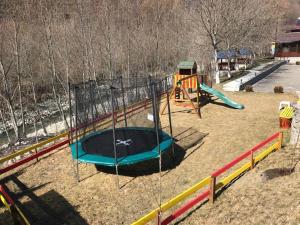 a park with a playground with a slide and a swing at La Păstrăvărie ,,Casa Iov,, in Moroeni