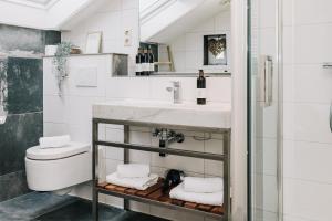 a bathroom with a sink and a toilet at Divi Divi Zandvoort in Zandvoort +30 photos