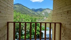 a balcony with a view of the mountains at Eco Cottage Rose in Borjomi