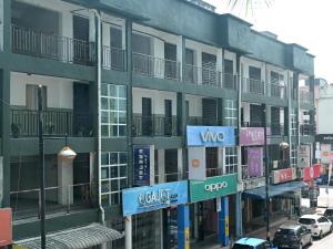 a building with signs on the side of a street at Juichi Homestay in Kluang