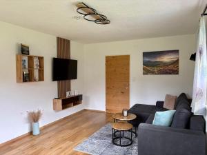 a living room with a couch and a table at Natura Aparts in Stanzach