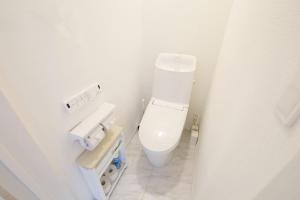 a white bathroom with a toilet and a sink at Dual Residence Nakijin A in Koechi +77 photos