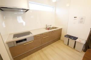 a kitchen with a sink and a counter top at Dual Residence Nakijin A in Koechi