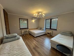 a bedroom with two beds and a chandelier at Dom Nad Brzegiem Wisły in Mozolice Małe +37 photos