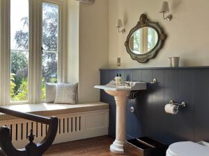 a bathroom with a sink and a window at The Green in Wingfield