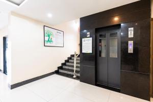 an elevator in a building with a staircase at Treebo Hotel Mobi VIP Airport in Guwahati