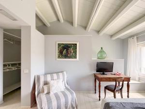a living room with a table and a chair at Borgoparvo Countryvilla in Sirolo