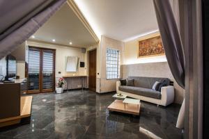 a living room with a couch and a table at Orchidea Catania in San Giovanni la Punta
