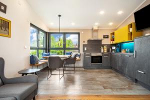 a kitchen and living room with a table and chairs at Wohnplatz 52 in Inzigkofen