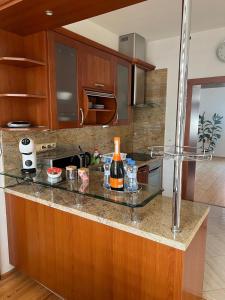 a kitchen with a counter with a bottle of wine on it at Apartmán pod věží Jevíčko in Jevíčko