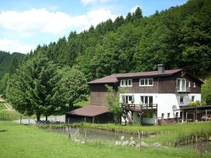a house in a field next to a mountain at Apartment in Lennestadt for 2 Person in Lennestadt