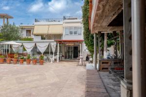 a patio in front of a white building at Ksamil Guesthouse Villa in Ksamil