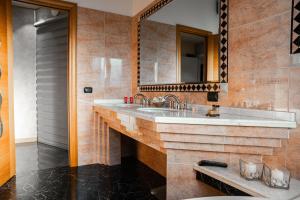 a bathroom with a sink and a mirror at Orchidea Catania in San Giovanni la Punta +37 photos