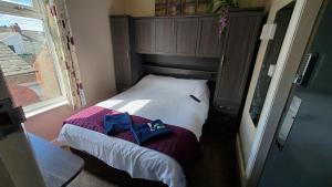 a small bed in a room with a window at Leecliff Guest House in Blackpool