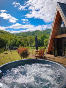 a hot tub in the backyard of a house at Transylvantures Cabin in Rimetea
