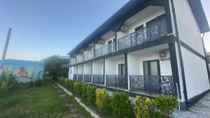 a building with a balcony on the side of it at Vila DVG Costinesti in Costinesti