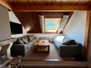 a living room with a couch and a table at Triplex 8 people 4 bedrooms in Saint-Chaffrey