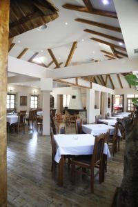a dining room with white tables and chairs at Motel Restoran DURMITOR in Nikoljac