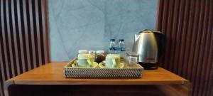 a table with a coffee maker and a tray of food at Umayuri Inn in Ubud