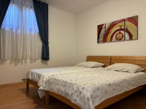a bedroom with a bed and a window at Apartma Eva in Portorož