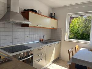 a small kitchen with a sink and a window at Apartma Eva in Portorož