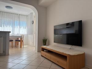 a living room with a large flat screen tv on a wall at Apartma Eva in Portorož