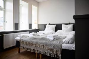 a bedroom with a bed with towels on it at Westergaards Hotel in Videbæk