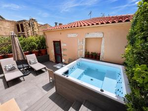 a hot tub on the patio of a house at Venetian Palace Chania - Adults Only in Chania