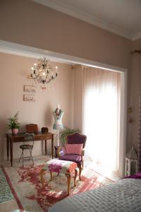 a living room with a table and a chandelier at Apartment Corinth in Korinthos