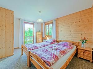 a bedroom with a bed and a wooden wall at Chalet Marinette in Icogne