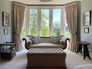 a living room with a couch in front of a window at The Green in Wingfield