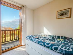 a bedroom with a bed and a balcony at Chalet Marinette in Icogne
