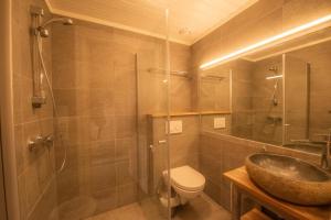 a bathroom with a sink and a toilet and a shower at Langedrag Naturpark in Tunhovd +73 photos