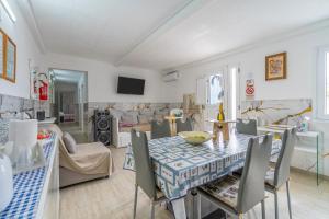 a living room with a table and chairs at Jungle Holiday Villa in Avola