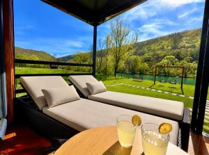 a screened in porch with two beds and a table at Aqua Vita Concept in Bihać