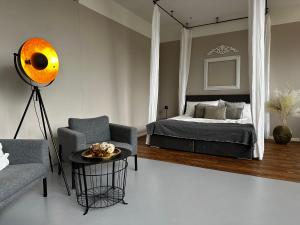a bedroom with a bed and a chair and a table at Ro42om Schönewerd in Schönenwerd +3 photos