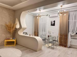 a living room with a table and a dining room at Zarisha Home in Fergana