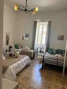 a living room with two beds and a couch at Ta Robert Farmhouse in San Lawrenz +21 photos