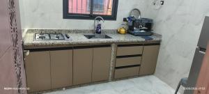 a kitchen with a sink and a counter top at Tata hausse in Tatta
