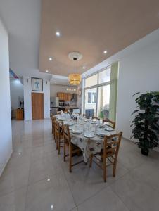 a large dining room with a table and chairs at Ta Robert Farmhouse in San Lawrenz