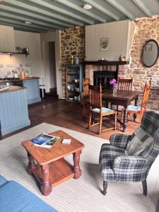 a living room with a table and chairs and a kitchen at La Ramée - 2 bedroom - Wi-Fi - Garden - Parking in Saint-Siméon +16 photos