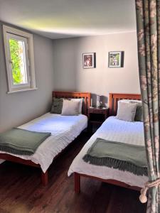 a bedroom with two beds and a window at La Ramée - 2 bedroom - Wi-Fi - Garden - Parking in Saint-Siméon