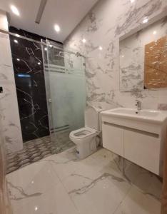 a bathroom with a toilet and a shower and a sink at Benslimane in Ben Slimane