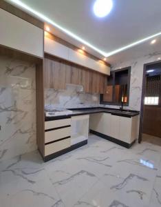a kitchen with marble floors and a counter top at Benslimane in Ben Slimane