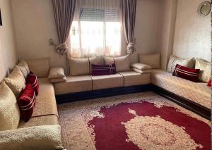 a living room with a couch and a window at Benslimane in Ben Slimane