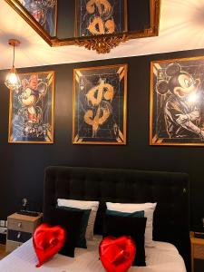 a bedroom with a bed with two red heart pillows at R.Suite in Saint-Étienne