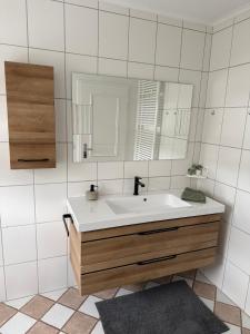 a bathroom with a sink and a mirror at Raelax in Raeren +19 photos