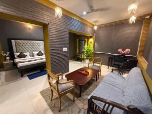 a living room with a couch and a table at Staylo Suites Edit in New Delhi