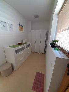 a kitchen with white cabinets and a sink and a window at Apartment Sommer-Tango in Byala
