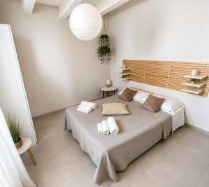 a bedroom with a large bed with two towels on it at Maison La Reggia in Caserta